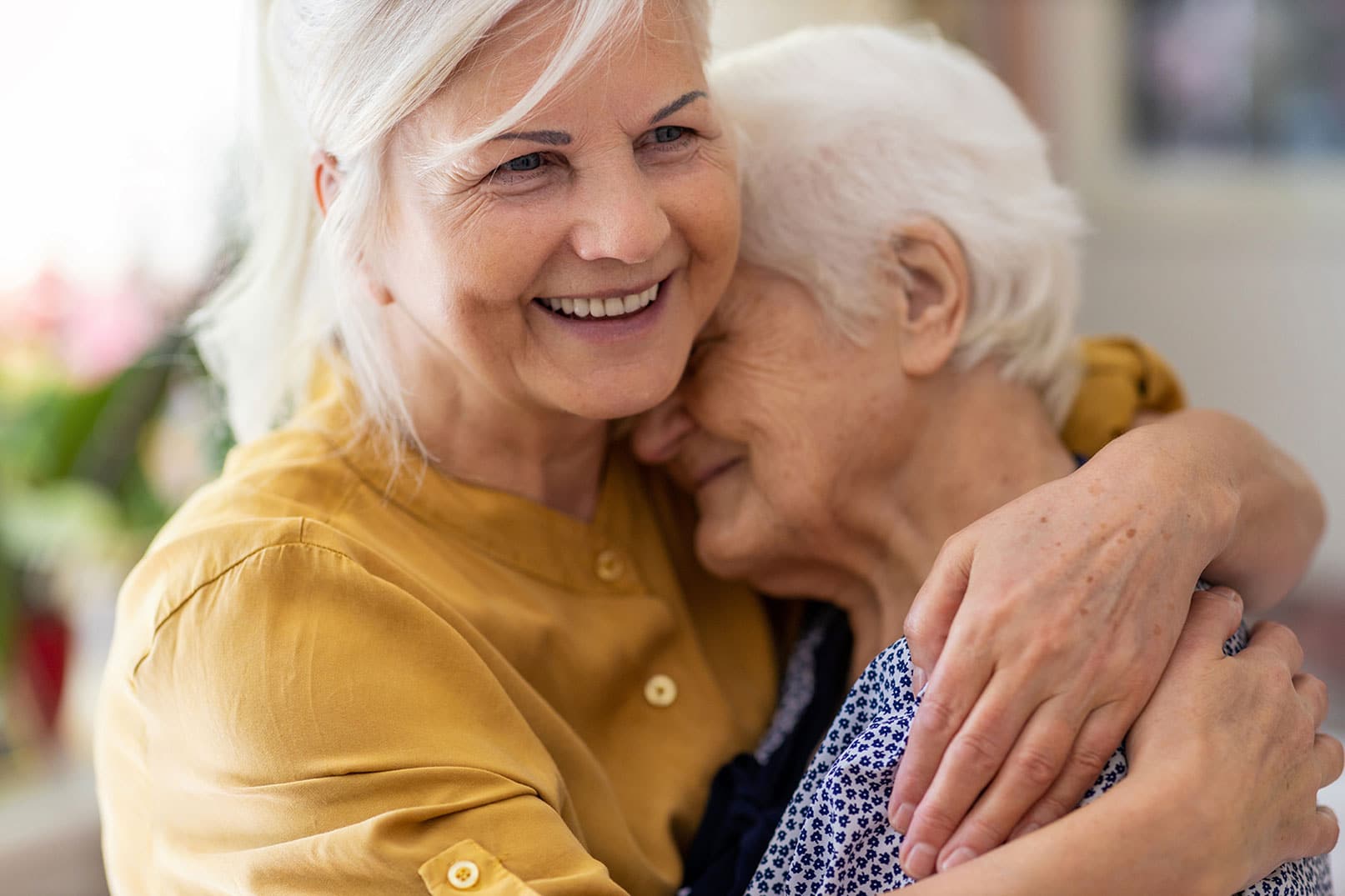 Senior woman hugging mom