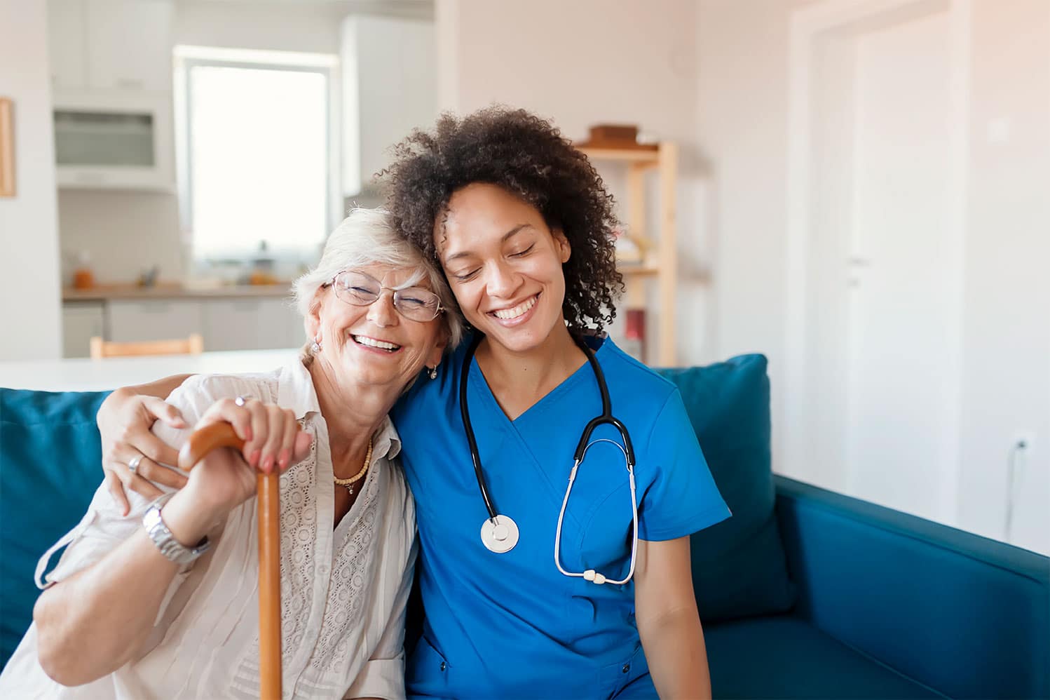 Senior woman with caregiver giving hug